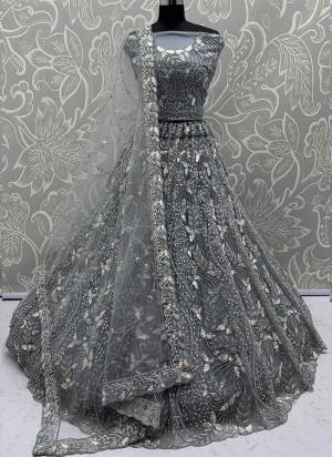 For A Fancy Designer Look,Grab These Lehenga Choli With Dupatta in Fine Colored.These Lehenga And Choli Are Net And Dupatta Are Fabricated On Net Pair.Its Beautified With Fancy Designer Dori,Rainbow Sequance Embroidery With Zarkan Work. 