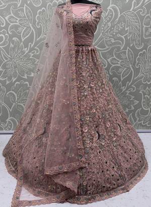 For A Fancy Designer Look,Grab These Lehenga Choli With Dupatta in Fine Colored.These Lehenga And Choli Are Net And Dupatta Are Fabricated On Net Pair.Its Beautified With  Peacock Pattern Crafted In Dori,Thread Embroidery With Zircon Diamond Work. 
