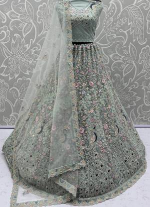 For A Fancy Designer Look,Grab These Lehenga Choli With Dupatta in Fine Colored.These Lehenga And Choli Are Net And Dupatta Are Fabricated On Net Pair.Its Beautified With  Peacock Pattern Crafted In Dori,Thread Embroidery With Zircon Diamond Work. 