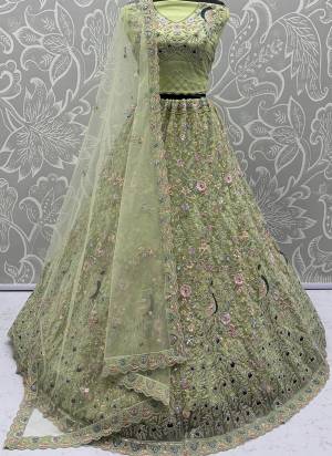 For A Fancy Designer Look,Grab These Lehenga Choli With Dupatta in Fine Colored.These Lehenga And Choli Are Net And Dupatta Are Fabricated On Net Pair.Its Beautified With  Peacock Pattern Crafted In Dori,Thread Embroidery With Zircon Diamond Work. 