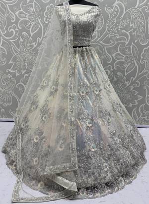 For A Fancy Designer Look,Grab These Lehenga Choli With Dupatta in Fine Colored.These Lehenga And Choli Are Net And Dupatta Are Fabricated On Net Pair.Its Beautified With Multy Thread, Rainbow Sequance Embroidery,Zarcon Diamond Work. 