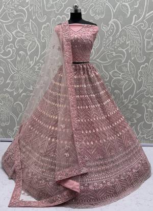 For A Fancy Designer Look,Grab These Lehenga Choli With Dupatta in Fine Colored.These Lehenga And Choli Are Net And Dupatta Are Fabricated On Soft Net Pair.Its Beautified With Dori, Sequance,Jari Embroidery,Zarkon Diamond Work. 