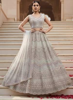 For A Fancy Designer Look,Grab These Lehenga Choli With Dupatta in Fine Colored.These Lehenga And Choli Are Net And Dupatta Are Fabricated On Soft Net Pair.Its Beautified With Heavy Designer Sequance,Dori Embroidery,Modif Crystal Pipe,Beads Hand Work. 