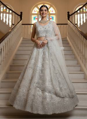 For A Fancy Designer Look,Grab These Lehenga Choli With Dupatta in Fine Colored.These Lehenga And Choli Are Net And Dupatta Are Fabricated On Soft Net Pair.Its Beautified With Heavy White Pearl Beads,Thread,Jari,Dori Embroidery,Zircon Diamond Work. 