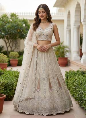 For A Fancy Designer Look,Grab These Lehenga Choli With Dupatta in Fine Colored.These Lehenga And Choli Are Bridal Net And Dupatta Are Fabricated On Soft Net Pair.Its Beautified With Fancy Dori, Sequance,Multy Thread,Jari Embroidery,Zarcon Diamond Work. 