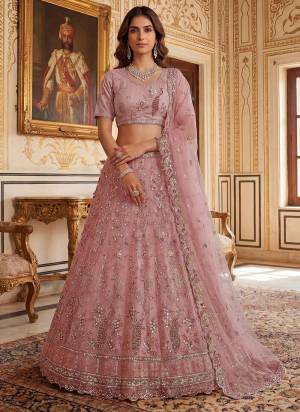 For A Fancy Designer Look,Grab These Lehenga Choli With Dupatta in Fine Colored.These Lehenga And Choli Are Net And Dupatta Are Fabricated On Net Pair.Its Beautified With Fancy Sequance, Thread Embroidery,Flower Beads,Crystal Pipe Hand Work. 
