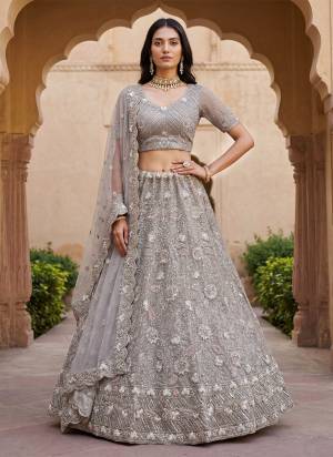 For A Fancy Designer Look,Grab These Lehenga Choli With Dupatta in Fine Colored.These Lehenga And Choli Are Net And Dupatta Are Fabricated On Net Pair.Its Beautified With Fancy Double Sequance,Dori,Viscose Multy Thread Embroidery,Zircon Diamond Work. 