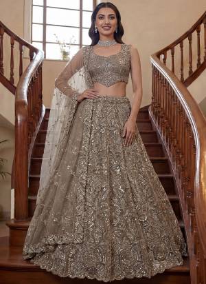 For A Fancy Designer Look,Grab These Lehenga Choli With Dupatta in Fine Colored.These Lehenga And Choli Are Net And Dupatta Are Fabricated On Net Pair.Its Beautified With Fancy Sequance,Thread Embroidery,Crystal Motif,Crystal Pipe Work. 