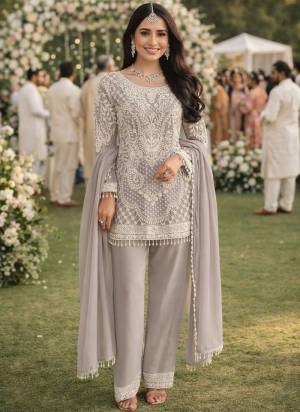 Attractive These Party Wear Salwar Suit in Fine Colored Pair With Bottom And Dupatta.These Top Are Catonic Georgette And Dupatta Are Fabricated On Organza Pair With Santoon Bottom.Its Beautified With Designer Thread Embroidery,Swarovski Work With Digital Brasso Printed Dupatta.