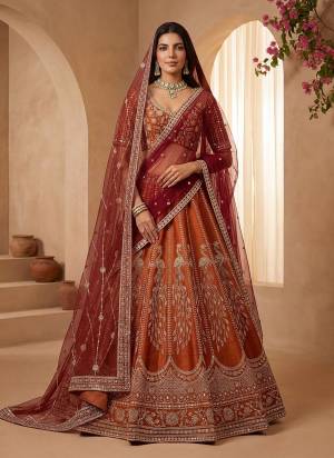 For A Fancy Designer Look,Grab These Lehenga Choli With 2 Dupatta in Fine Colored.These Lehenga And Choli Are Gadhwal Silk And Dupatta Are Fabricated On Net Pair.Its Beautified With Fancy Chapat Jari,Sequance,Multy Thread,Dori Embroidery,Crystal Hand Work. 