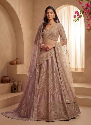For A Fancy Designer Look,Grab These Lehenga Choli With 2 Dupatta in Fine Colored.These Lehenga And Choli Are Gadhwal Silk And Dupatta Are Fabricated On Net Pair.Its Beautified With Fancy Chapat Jari,Sequance,Multy Thread,Dori Embroidery,Crystal Hand Work. 