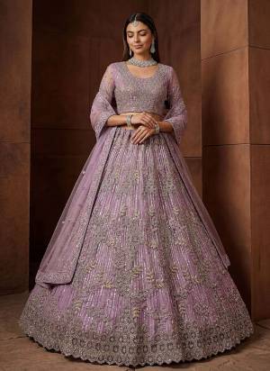 For A Fancy Designer Look,Grab These Lehenga Choli With Dupatta in Fine Colored.These Lehenga And Choli Are Net And Dupatta Are Fabricated On Net Pair.Its Beautified With Fancy Jari,Sequance,Dori Embroidery,Zircon Diamond Work. 