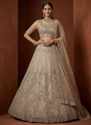 For A Fancy Designer Look,Grab These Lehenga Choli With Dupatta in Fine Colored.These Lehenga And Choli Are Net And Dupatta Are Fabricated On Net Pair.Its Beautified With Fancy Jari,Sequance,Dori Embroidery,Zircon Diamond Work. 