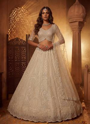 For A Fancy Designer Look,Grab These Lehenga Choli With Dupatta in Fine Colored.These Lehenga And Choli Are Net And Dupatta Are Fabricated On Soft Net Pair.Its Beautified With Fancy Patten,Intricate Boota,Sequance Embroidery,Motif Crystal Work. 