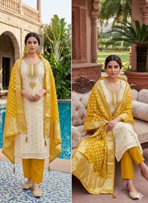 Attractive This Suits In Lovely Color.Its Pretty Top Is Simmer Jacquard Based Paired Bottom Santoon And Organza Fabricated Dupatta Are Woven Butti Designer With Embroidery Work .