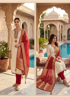 Attractive This Suits In Lovely Color.Its Pretty Top Is Simmer Jacquard Based Paired Bottom Santoon And Organza Fabricated Dupatta Are Woven Butti Designer With Embroidery Work .