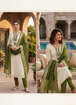 Attractive This Suits In Lovely Color.Its Pretty Top Is Simmer Jacquard Based Paired Bottom Santoon And Organza Fabricated Dupatta Are Woven Butti Designer With Embroidery Work .