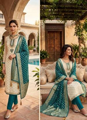 Attractive This Suits In Lovely Color.Its Pretty Top Is Simmer Jacquard Based Paired Bottom Santoon And Organza Fabricated Dupatta Are Woven Butti Designer With Embroidery Work .