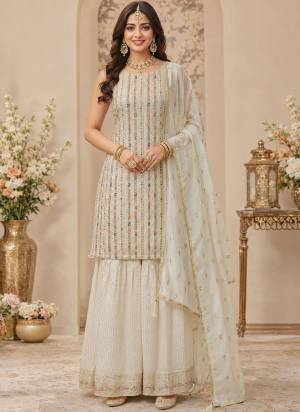 Attractive These Party Wear Sharara Suit in Fine Colored Pair Sharara With Dupatta.These Top And Dupatta Are Georgette And Viscose Jacquard Bottom Fabricated.Its Beautified With Woven Jacquard Designer With Embroidery,Swarovski Zarkan Work.