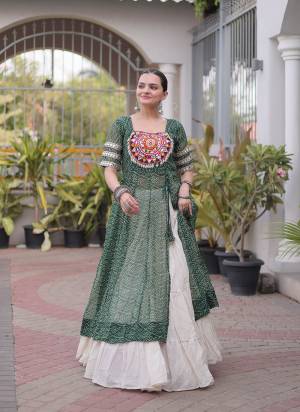 Garb These Navratri Wear Lehenga Kurti in Fine Colored. These Lehenga Are Kora Cotton And Kurti Are Faux Georgette Fabricated. It is Beautified With Designer Bandhani Printed With Kutchi Patch Work.