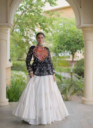 Garb These Navratri Wear Lehenga Choli in Fine Colored. These Lehenga Are Kora Cotton And Blouse Are Faux Georgette Fabricated. It is Beautified With Designer Bandhani Printed With Kutchi Gamthi Patch Work.