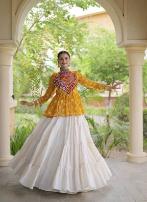 Garb These Navratri Wear Lehenga Choli in Fine Colored. These Lehenga Are Kora Cotton And Blouse Are Faux Georgette Fabricated. It is Beautified With Designer Bandhani Printed With Kutchi Gamthi Patch Work.