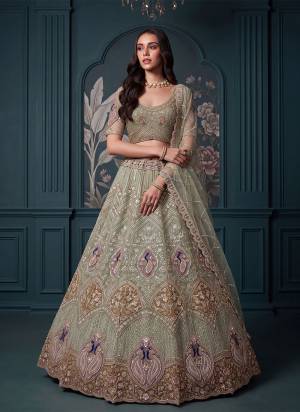 For A Fancy Designer Look,Grab These Lehenga Choli With Dupatta in Fine Colored.These Lehenga And Choli Are Net And Dupatta Are Fabricated On Soft Net Pair.Its Beautified With Jari,Sequance Embroidery,Motif Crystel Beads Hand Work. 