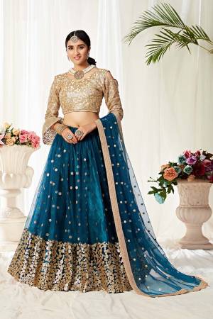 Heavy Designer Lehenga Choli In Golden And Blue Color Fabricated On Net Beautified With Heavy Attractive Embroidery. 