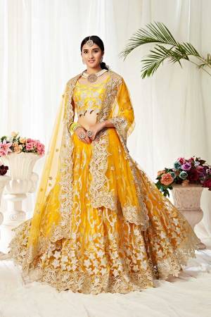 Heavy Designer Lehenga Choli In Yellow Color Fabricated On Net Beautified With Heavy Attractive Embroidery. 