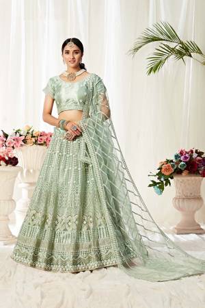 Heavy Designer Lehenga Choli In Pastel Green Color Fabricated On Net Beautified With Heavy Attractive Embroidery. 