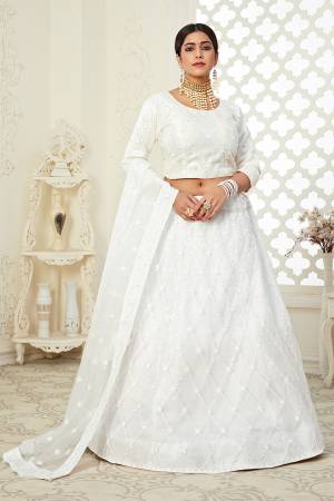 Heavy Designer Lehenga Choli In White Color Fabricated On Net Beautified With Heavy Attractive Embroidery. 