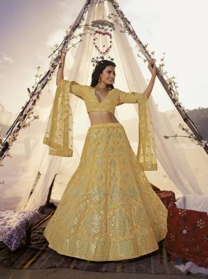 Heavy Designer Lehenga Choli In Light Base Color Fabricated On Organza Beautified With Heavy Attractive Embroidery With Mirror And Soft Net Dupatta. 