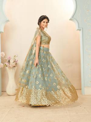 Heavy Designer Lehenga Choli And Dupatta In Light Color Fabricated On Soft Net Beautified With Heavy Attractive Sequance Thread Dori Embroidery. 