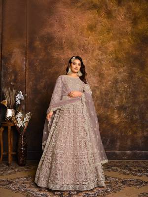 Flaunt Your Rich And Elegant Taste Wearing This Heavy designer Floor Length Suit In All Over Pink Color. Its Top And Dupatta Are Net In Heavy Embroidry Based Paired With Santoon Bottom.