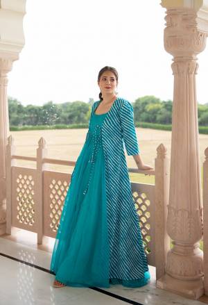 Flaunt Your Rich And Elegant Taste Wearing This Designer Readymade Long Gown In Teal Color And Jacket In Sky Blue Color. This  Pretty Gown Is Fabricated On Maslin Beautified And Jacket Is Chanderi Silk Are Digital Print . Its Fabric Is Soft Towards Skin And Easy To Carry All Day Long. 