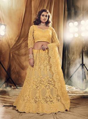 This Wedding Season Heavy Designer Lehenga Choli In Yellow Color Fabricated On Net Beautified With Heavy Attractive Cording Embroidery With Dupatta. 