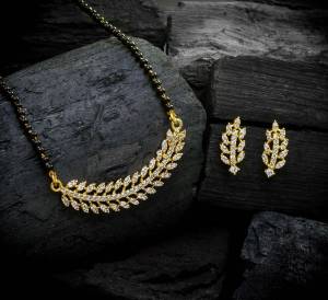 Look To Your Personality By Pairing Up This Beautiful Mangal Sutra Set With Your Ethnic Attire. This Pretty Set Is In Gold Color Beautified With American Diamond Work. Buy Now.