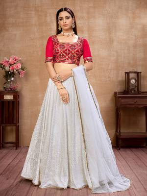 Here Is Lovely and Elegant Looking Designer Lehenga Choli In Rani Colored Blouse Paired With White Colored Lehenga And White Dupatta. Its Blouse Is Silk Based Paired With Georgette Fabricated Lehenga And Net Fabricated Dupatta. Buy Now. 