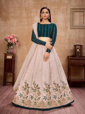 Here Is Lovely and Elegant Looking Designer Lehenga Choli In Teal Colored Blouse Paired With Beige Colored Lehenga And Beige Dupatta. Its Blouse Is Georgette Based Paired With Art Silk Fabricated Lehenga And Net Fabricated Dupatta. Buy Now. 