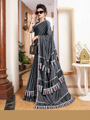 Add This Trendy Designer Ruffle Saree To Your Wardrobe In English Color. This Pretty Saree Is Fabricated On Imported Paired With Blouse. It Is Beautified With Pretty Ruffles And Hand Embroidered Patch Work.

