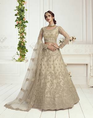 Get Ready For The Upcoming Wedding and Festive Season Wearing This Heavy Designer Lehenga Choli In Light Color. Its Blouse And Lehenga Are Fabricated On Net Beautified With Heavy Attractive Embroidery. 

