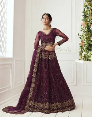 Get Ready For The Upcoming Wedding and Festive Season Wearing This Heavy Designer Lehenga Choli In Dark Color. Its Blouse And Lehenga Are Fabricated On Net Beautified With Heavy Attractive Embroidery. 

