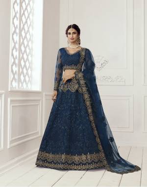 Get Ready For The Upcoming Wedding and Festive Season Wearing This Heavy Designer Lehenga Choli In Dark Color. Its Blouse And Lehenga Are Fabricated On Net Beautified With Heavy Attractive Embroidery. 

