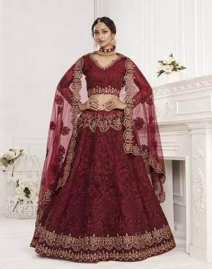 Get Ready For The Upcoming Wedding and Festive Season Wearing This Heavy Designer Lehenga Choli In Dark Color. Its Blouse And Lehenga Are Fabricated On Net Beautified With Heavy Attractive Embroidery. 

