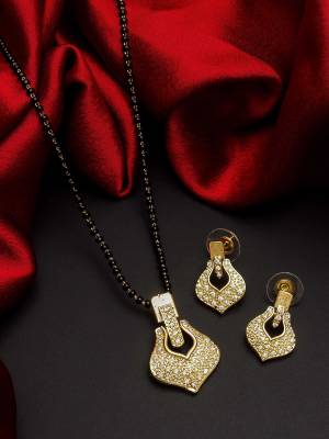 Give An Enhanced Look To Your Personality By Pairing Up This Beautiful Mangal Sutra Set With Your Ethnic Attire. This Pretty Set Is In Gold Color Beautified With American Diamond. Buy Now.