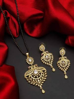 Give An Enhanced Look To Your Personality By Pairing Up This Beautiful Mangal Sutra Set With Your Ethnic Attire. This Pretty Set Is In Gold Color Beautified With American Diamond. Buy Now.