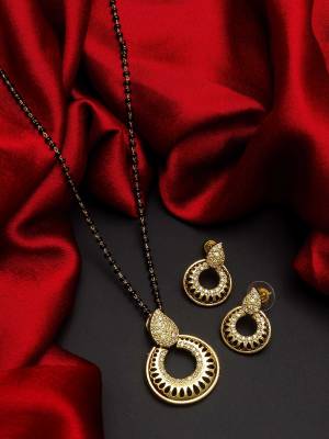 Give An Enhanced Look To Your Personality By Pairing Up This Beautiful Mangal Sutra Set With Your Ethnic Attire. This Pretty Set Is In Gold Color Beautified With American Diamond. Buy Now.