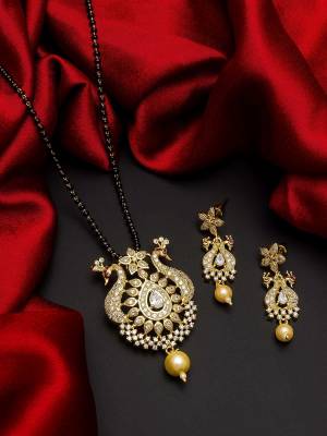 Give An Enhanced Look To Your Personality By Pairing Up This Beautiful Mangal Sutra Set With Your Ethnic Attire. This Pretty Set Is In Gold Color Beautified With American Diamond. Buy Now.