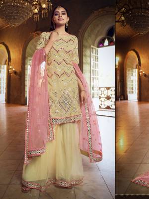 Get Ready For The Upcoming Festive And Wedding Season Wearing This Heavy Designer Embroidery With Foil Mirror Work Sharara Suit In Light Color. Its Top Are Fabricated Organza And Bottom And Dupatta Are Fabricated on Soft Net. Buy Now.