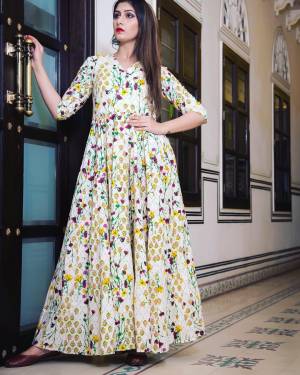 Flaunt Your Rich And Elegant Taste Wearing This Designer Readymade Long Gown In Cream Color. This  Pretty Gown Is Fabricated On Maslin Beautified With Digital Printed. Its Fabric Is Soft Towards Skin And Easy To Carry All Day Long. 